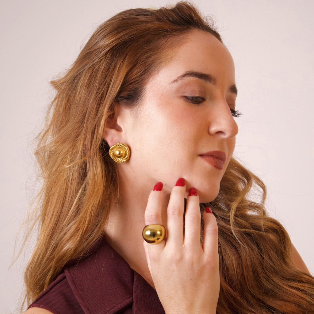 Elegant gold earrings styled on model for a refined everyday look
