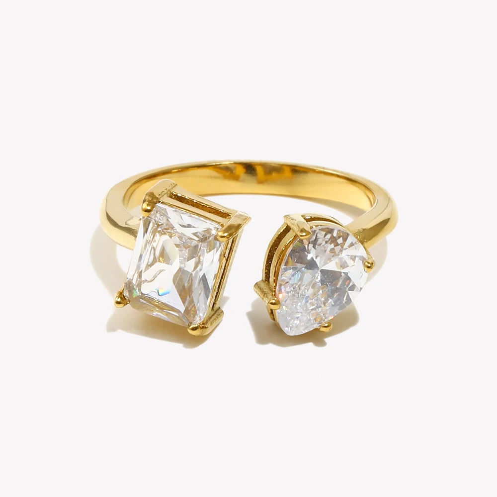 Gold open ring featuring two clear crystal stones in different shapes
