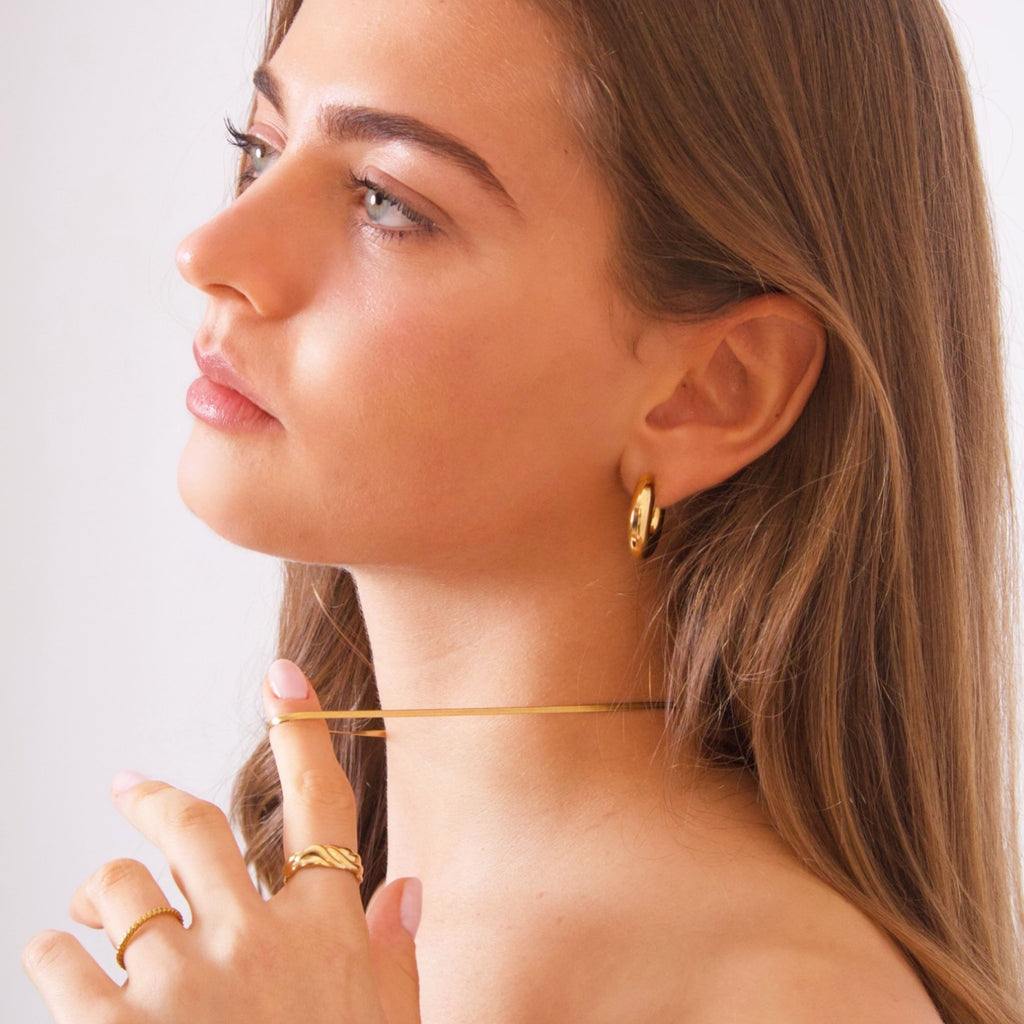 Gold snake chain necklace showing flexible fluid drape and smooth links
