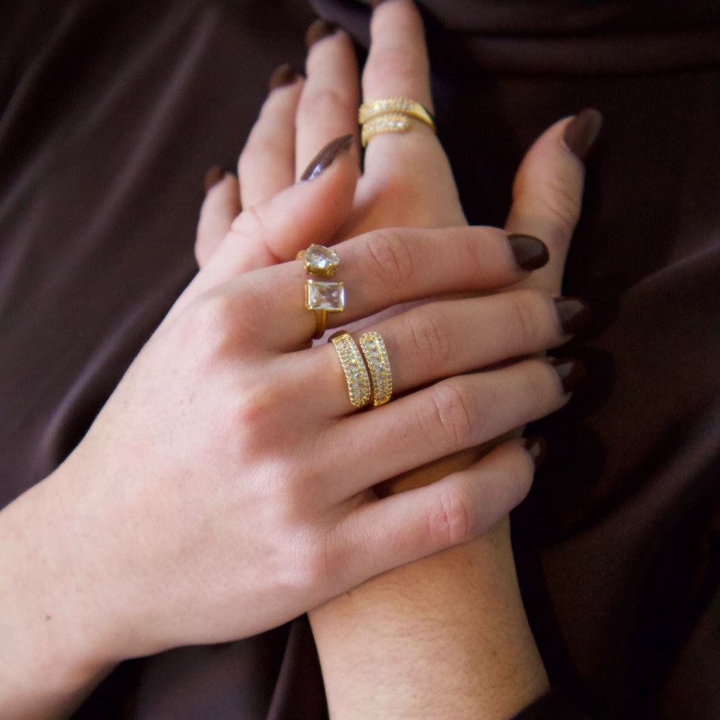 Gold statement ring with pavé detailing worn on hand
