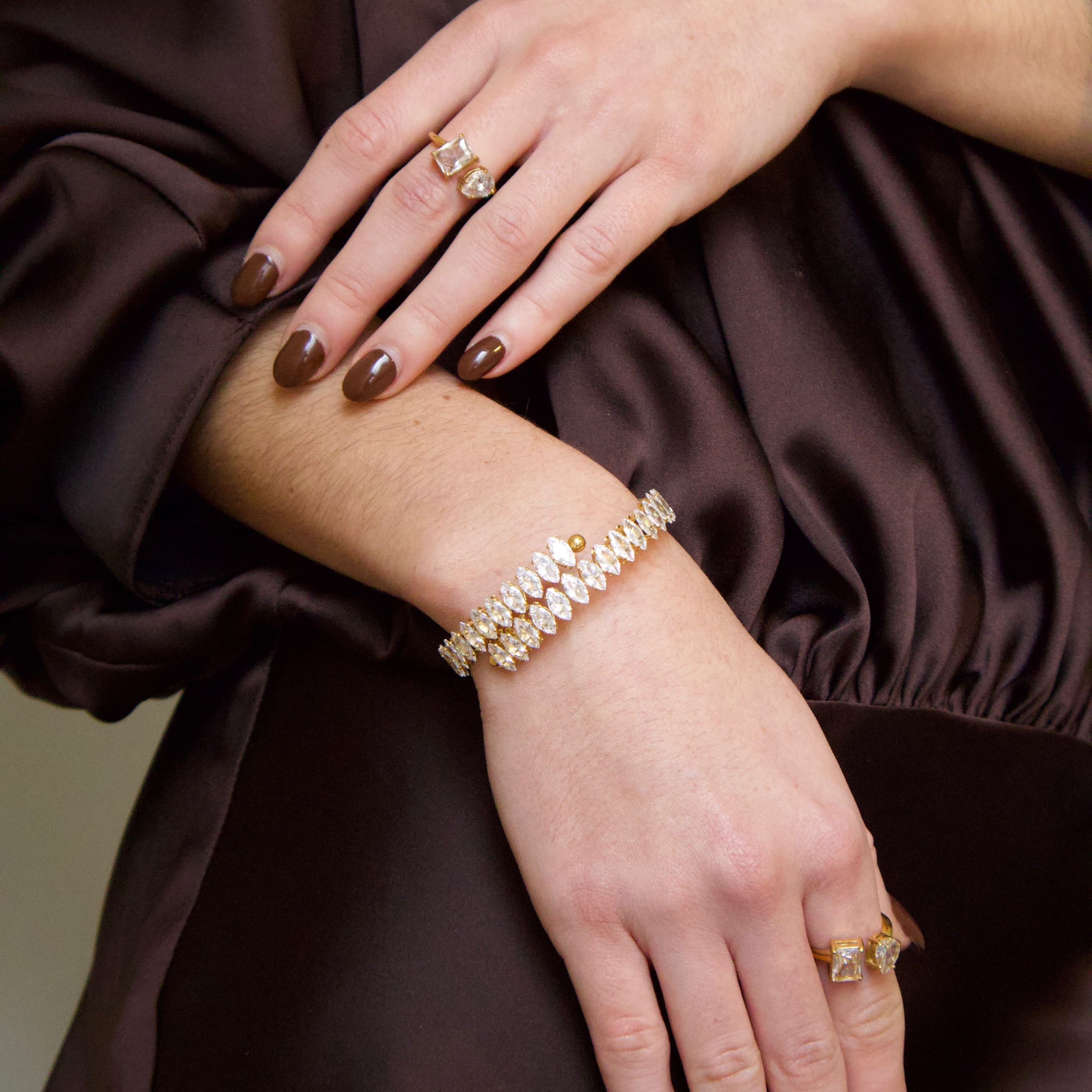 Gold bracelet featuring a continuous row of marquise-cut clear crystals
