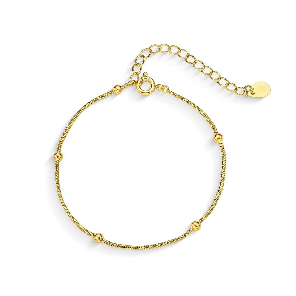Minimal gold chain bracelet with small bead details and adjustable clasp on white background
