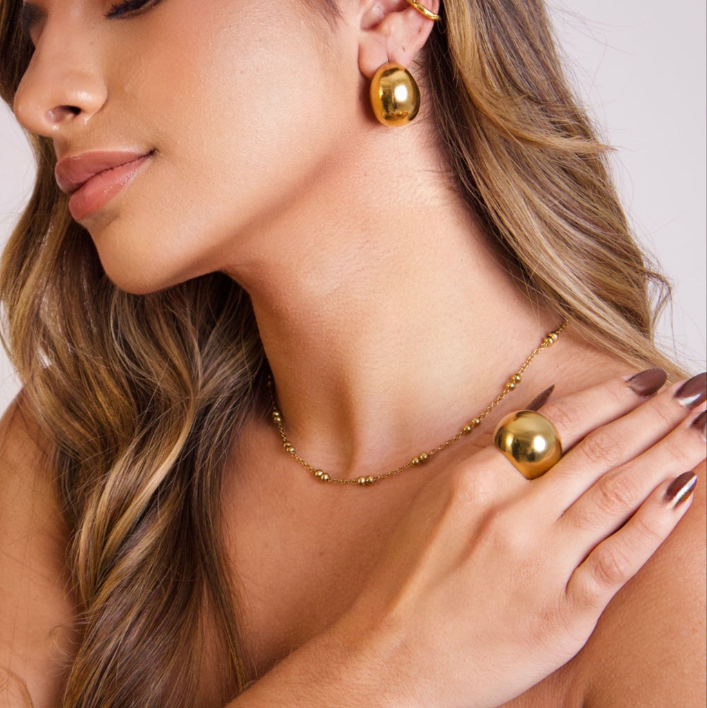 Minimalist gold sphere ring with a polished stainless steel finish