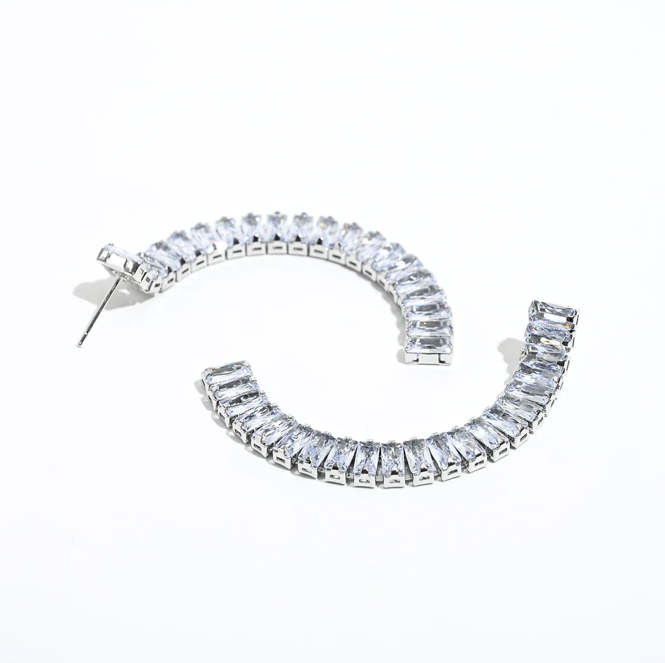 Silver crystal bar drop earrings with clear stones in curved design
