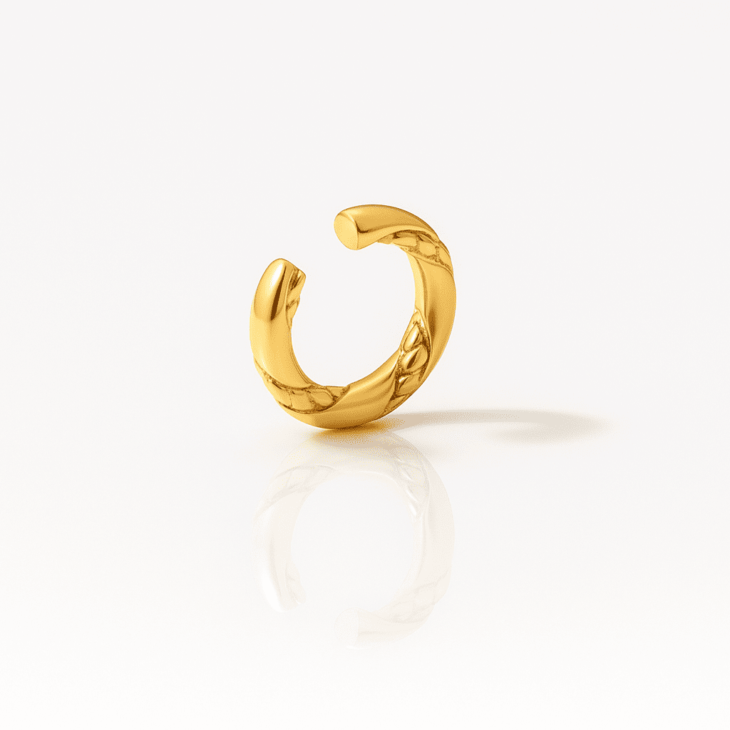 Twisted gold ear cuff with subtle braided texture and polished shine, minimalist stainless steel jewelry piece on a white background.