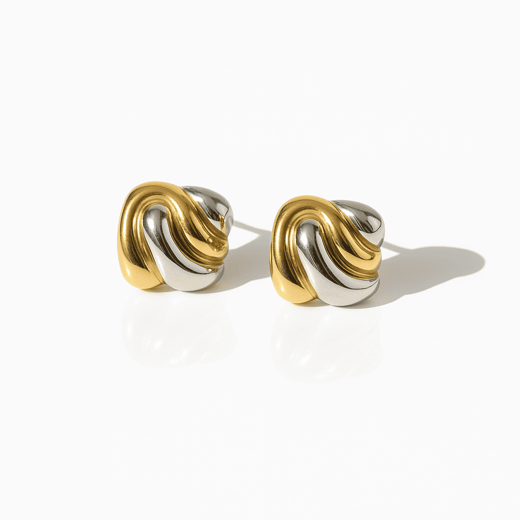 Two-tone knot earrings in gold and silver stainless steel with a modern, minimalist design on a white background.